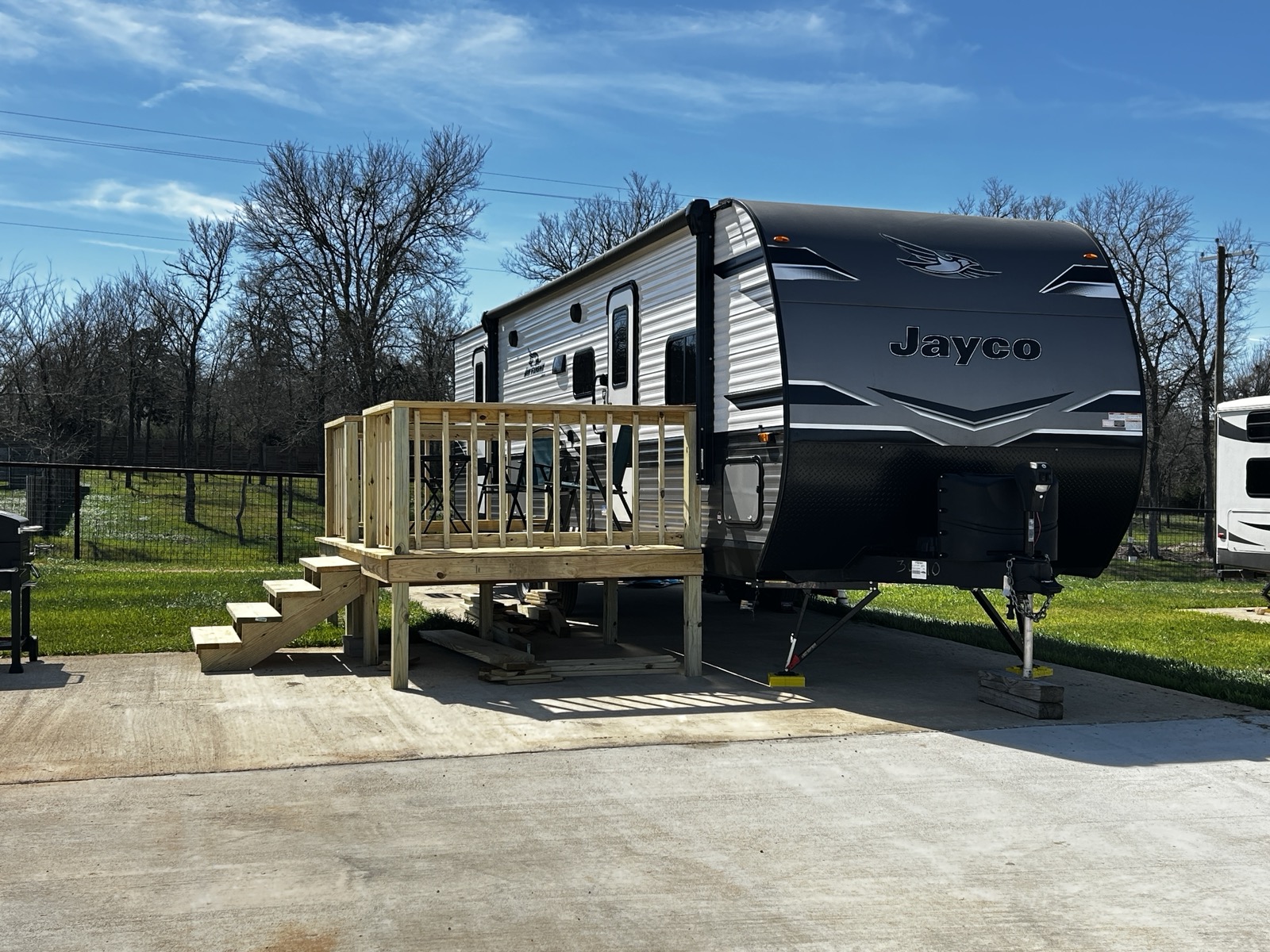 RV camper with wooden deck for accessibility